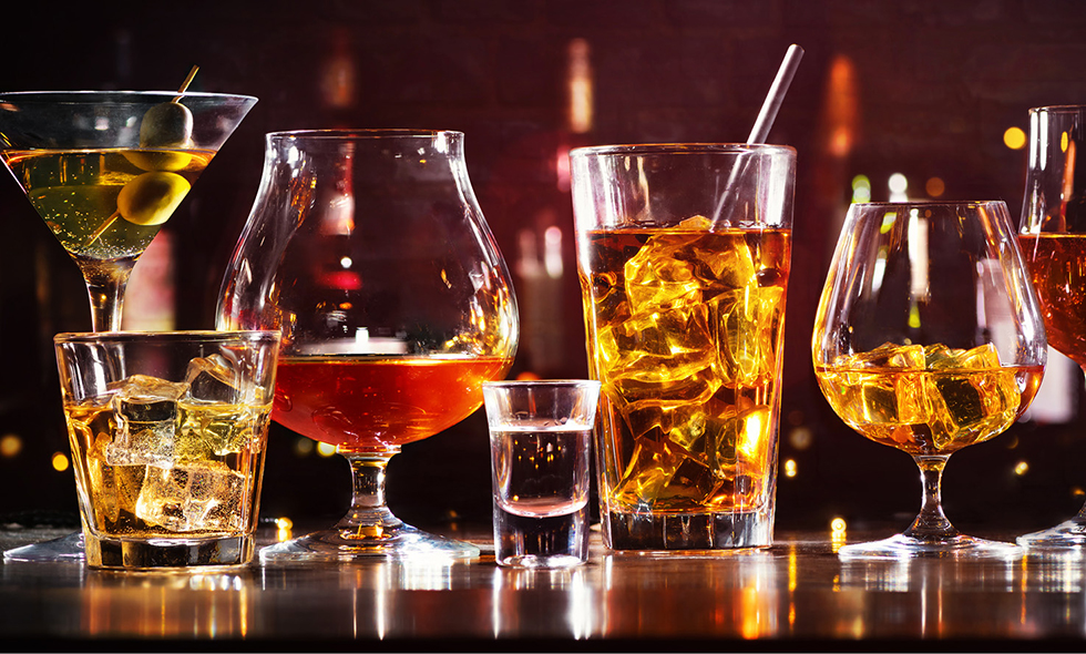Diferentes vasos que contienen diversas cantidades y tipos de alcohol. 