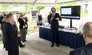 NIBIB Director Bruce J. Tromberg demonstrates a COVID-19 antigen test to a group of U.S. Senators on the NIH campus in Bethesda. The test was developed with support from NIH RADx Tech/ATP. 